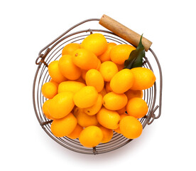 Basket with tasty kumquat fruits on white background