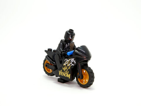 Venom. Lego toy. Arch enemy of Batman. Toy figure. Marvel. DC comics. Isolated white.Fight of good against evil. Motorcycle, motorbike, vehicle.