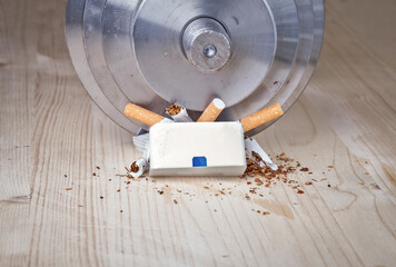 dumbbell smash pack of cigarettes breaking them