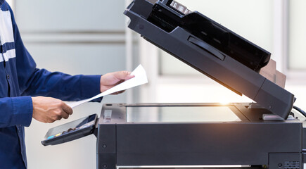 Businessman press button on panel of printer photocopier  network , Working on photocopies in the...