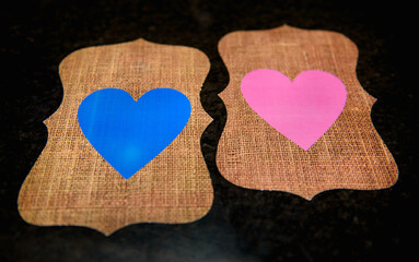 Fototapeta na wymiar Blue and Pink hearts on wooden background