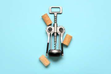 Wine corks and opener on blue background