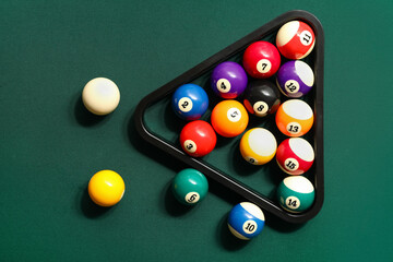 Rack with billiard balls on green table - obrazy, fototapety, plakaty