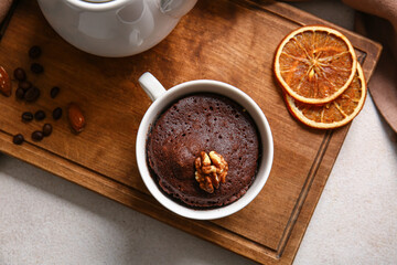 Cup with tasty chocolate brownie on table
