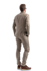 businessman standing with his hands in pockets, wearing eyeglasses