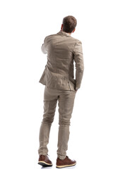 Fototapeta premium businessman pondering something, holding one hand in pocket