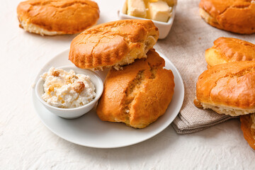 Plate of tasty sochniki with cottage cheese on white background