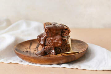 Plate with pieces of tasty chocolate brownie on table
