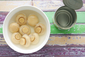Canned mushrooms in blow on white background 