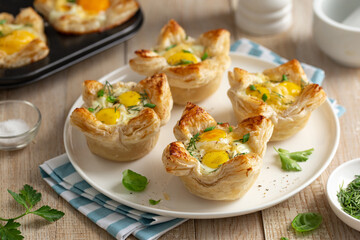 savory puff pastry cups with egg and cheese - 483755559