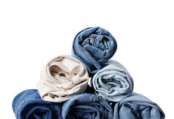 Fototapeta premium Stack of different rolled jeans on white background, closeup