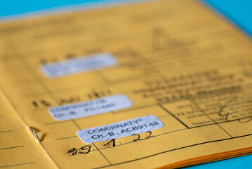 European type yellow vaccination passport with covid-19 vaccination marks. international certificates of vaccination or prophylaxis