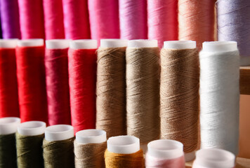 Closeup view of multicolor sewing threads on coils