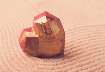 Diamond heart, rose gold color, chocolate bomb, handmade candy, on the sand, Valentine, horizontal, no people,