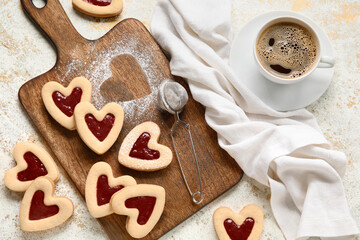Board with tasty cookies and cup of coffee for Valentine's Day celebration on light background