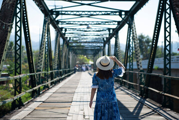 Woman traveller sightseeing on Pai Memorial bridge in Pai, Chiang Mai, Thailand.