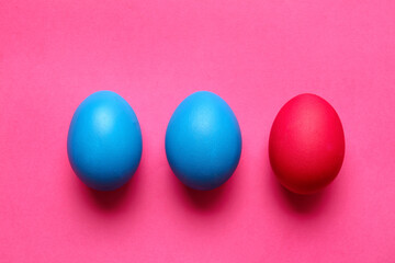 Blue and red Easter eggs on color background