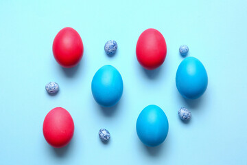 Different painted Easter eggs on color background