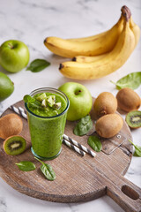 Detox smoothie with kiwi fruit, green apples, avocado, spinach and bananas. Healthy diet organic beverage.