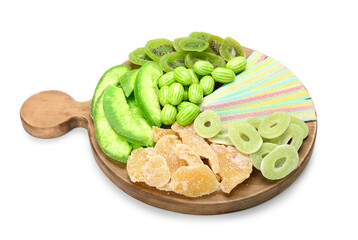 Wooden board with different sweets for St. Patrick's Day celebration on white background