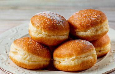 Austrian and german donuts - krapfen.  Berliner with cream. On white table. Selective focus.