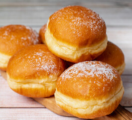 Sweet Sensations: Austria's Krapfen Meets Germany's Cream-Stuffed Berliner Donut Mastery. On white table. Selective focus.