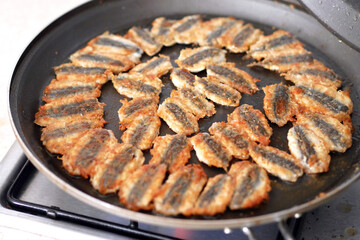 Anchovy is fried in a pan, cooking Turkish style anchovy, fried fish,