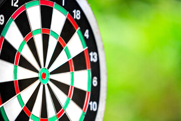 dartboard closeup with blur bokeh of forest background for objective business target, dart board...