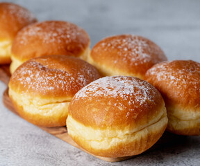 Obraz na płótnie Canvas Continental Cravings: Creamy Centers in German Berliners and Austrian Krapfen Pastries. On white table. Selective focus.