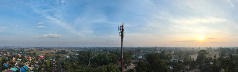 Telecommunication tower of 4G and 5G cellular. Macro Base Station. 5G radio network telecommunication equipment with radio modules and smart antennas mounted on a metal on cloulds sky background.