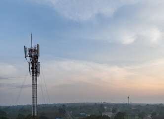 Telecommunication tower of 4G and 5G cellular. Macro Base Station. 5G radio network telecommunication equipment with radio modules and smart antennas mounted on a metal on cloulds sky background.