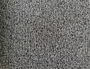 Doormat, gray and black for background.