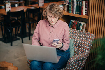 Young caucasian woman working via laptop at the cafeteria