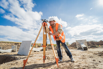 Surveyor worker with theodolite equipment at construction site - obrazy, fototapety, plakaty