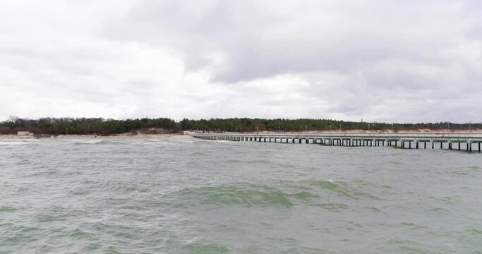 Wavy water on a beach on cloudy day, Lithuania.