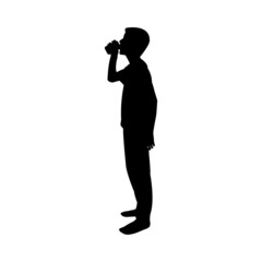 Silhouette of male kid drinking soda from a can