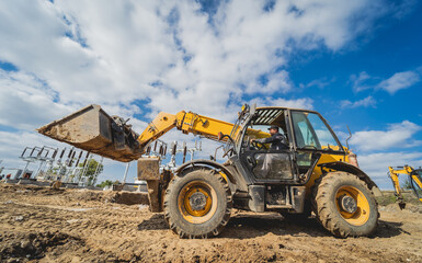 Wheel loader excavator works at construction site