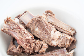 Steak ribs in a bowl of blanching on a white background