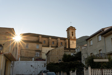 Fototapeta na wymiar Church bell tower against blue sky in Terrateig (Valencia, Spain).
