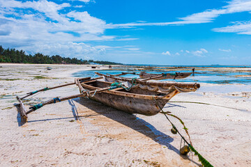 old fishing boat on the beach of zanzibar, tanzania