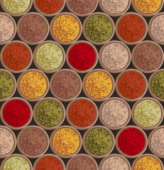 Spices powders in wooden bowls top view. Seamless texture with spices in abstract style on dark background. Food illustration. 