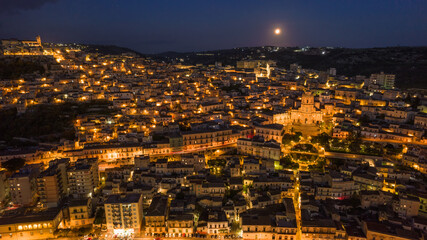 Aerial View of Modica City Centre at Night with the Lunar Eclipse, Ragusa, Sicily, Italy, Europe
