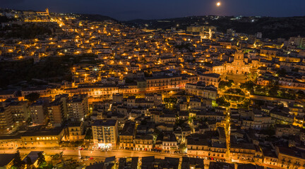 Aerial View of Modica City Centre at Night with the Lunar Eclipse, Ragusa, Sicily, Italy, Europe