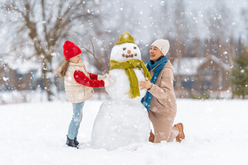 Mother and child girl on a winter walk