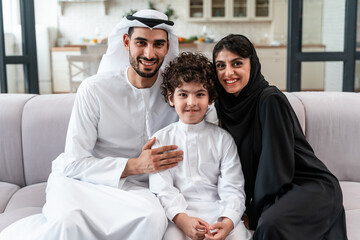 happy family spending time together. Arabian parents and their son playing and making different activities at home