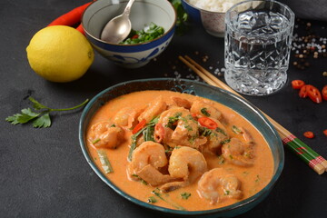 Thai shrimps red curry. Thailand tradition red curry soup with shrimps prawns and coconut milk. Panaeng Curry and dark background.