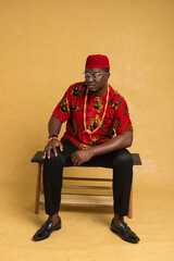 Igbo Traditionally Dressed Business Man Sitting Down and Looking Down