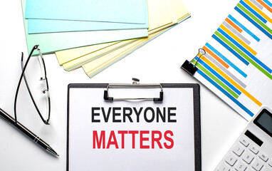 EVERYONE MATTERS text on paper sheet with chart,color paper and calculator