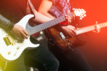 Obraz na płótnie Canvas Two guitarists performing at a live concert.