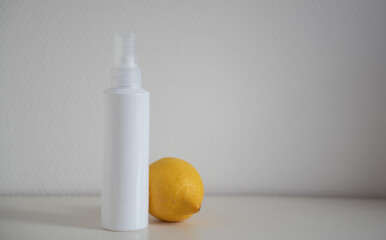 Flacon cosmétique blanc sur fond blanc avec citron jeune - mockup produit de beauté avec citron